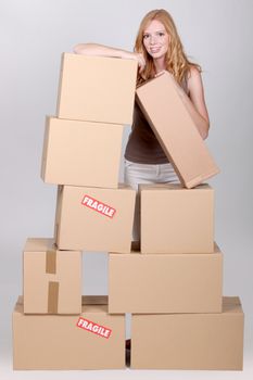 Young woman surrounded by cardboard boxes