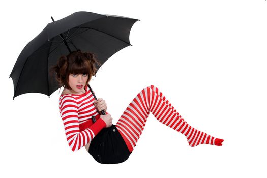 sexy woman in striped stockings holding umbrella