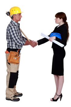 Architect and construction worker shaking hands