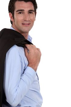 Successful businessman posing with jacket over shoulder