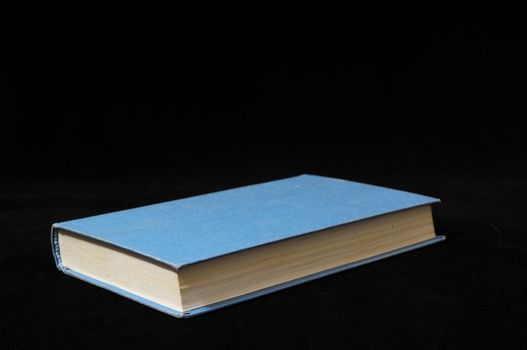 One Empty Book Isolated on a Black Background