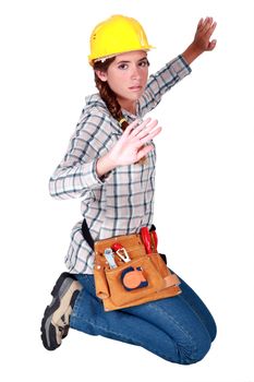 A female construction worker trapped in an invisible box.