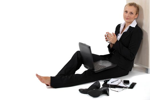 Relaxed businesswoman using her laptop