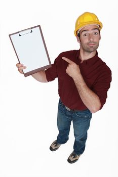 Construction worker pointing at his clipboard.