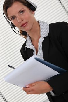 Office worker with a headset and clipboard