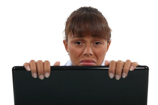 Upset woman behind laptop