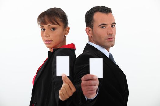 Businessman and woman holding calling cards