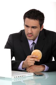 Man sat eating hamburger