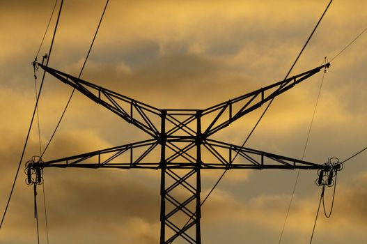 Power Electric Tower on a Cloudy Sky at Sunset