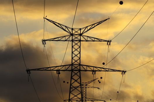 Power Electric Tower on a Cloudy Sky at Sunset