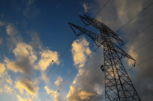 Power Electric Tower on a Cloudy Sky at Sunset