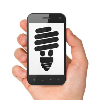 Business concept: hand holding smartphone with Energy Saving Lamp on display. Generic mobile smart phone in hand on White background.