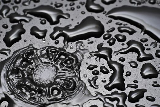 A water drop splashes into a pool of water
