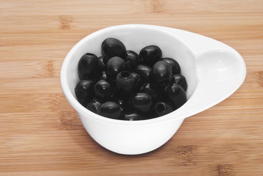 Pitted black olives in bowl