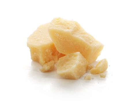 Pieces of hard cheese on the white background