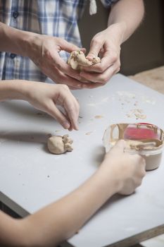 Girl make toyfrom clay. High resolution image.