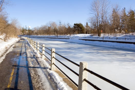 Sidewalk along Rideau Canal in winter day