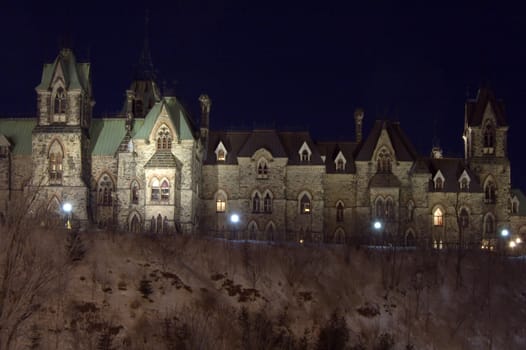 High shore of river under snow and the Parlament in Ottawa