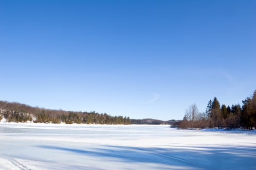 Winter ice lake and stone shore