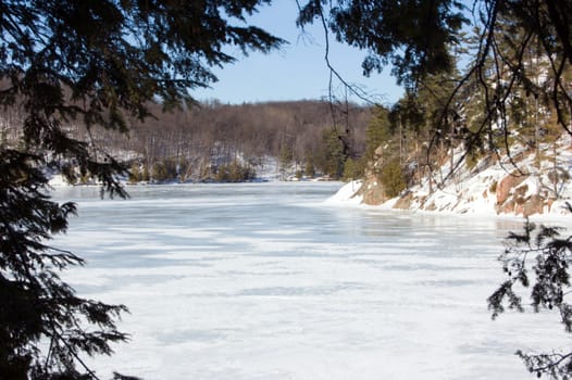 Winter ice lake and stone shore