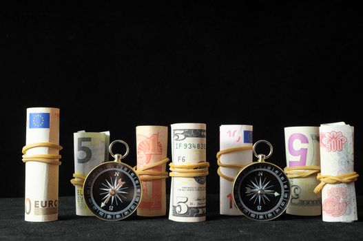 Orientation in  Business Compass and Money on a Black Background