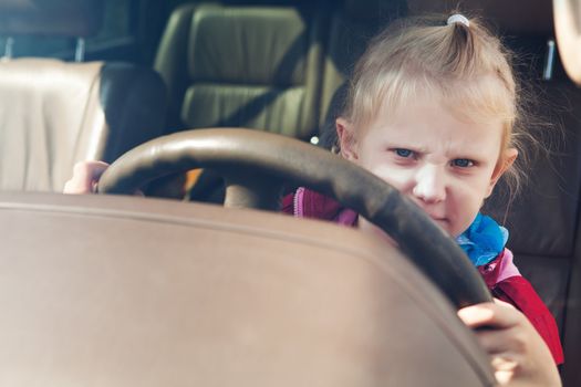 small girl driving a car