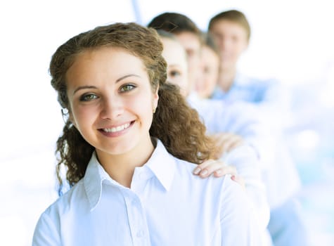 portrait of a young business woman standing in line with colleagues, concept of teamwork
