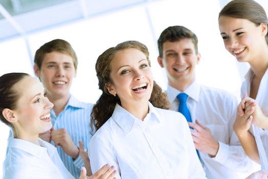 Successful business woman receiving congratulations from his colleagues, business success