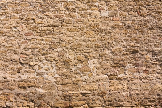 Old wall made of the Jerusalem stone. Wall constructed of stone bricks.