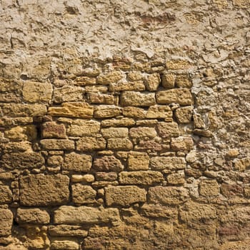 Old wall made of the Jerusalem stone. Wall constructed of stone bricks.