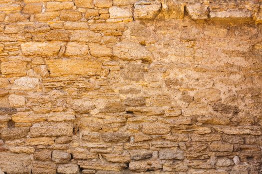 Old wall made of the Jerusalem stone. Wall constructed of stone bricks.