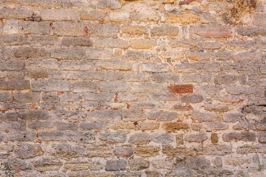 Old wall made of the Jerusalem stone. Wall constructed of stone bricks.