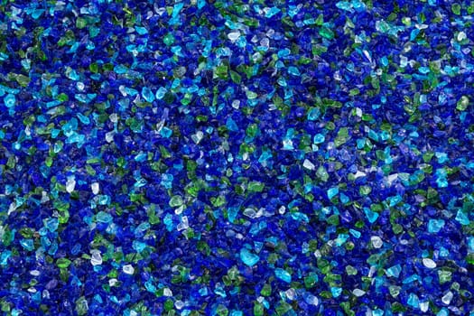 Background of blue shiny pieces of decorative glass.