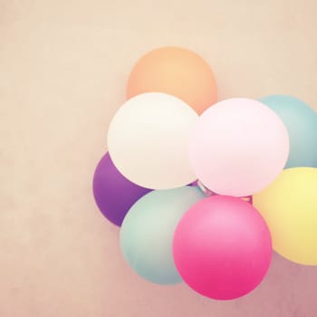 Colorful balloons on wall with retro filter effect