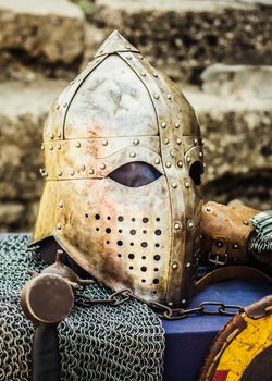 Protective helmet with a visor on medieval knight. Medieval Templar helmet waiting for knight