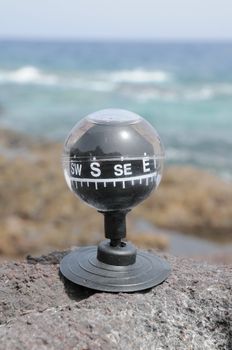 One Compass on the Rocks near the Atlantic Ocean