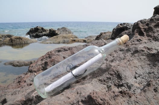 Message in the Bottle on the Rocks near the Beach