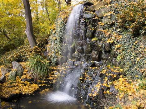 Shot of the waterfall in the autumn park