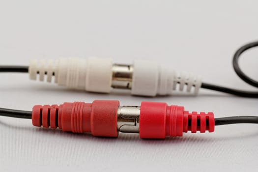 correct conection between left - right audio RCA cable on a white background (red white)