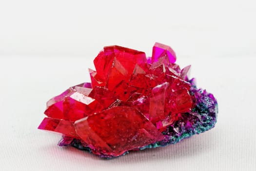 close up of crystals in ruby color on white background (red crystal)