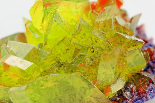 Close up picture about a crystal with topaz color on white background (yellow crystal)