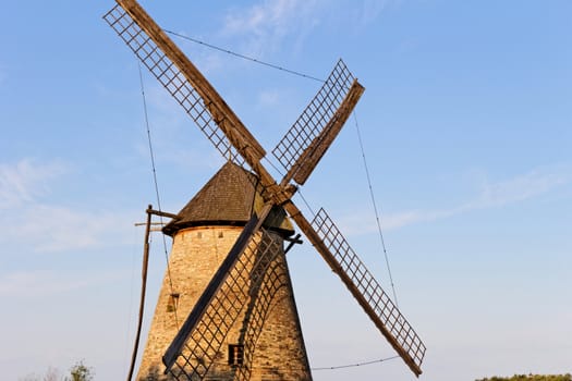 Old wooden windmill against the blue sky