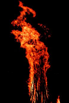 red flames of huge bonfire or campfire as black backgorund