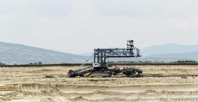 Coal mining in an open pit with huge industrial machine