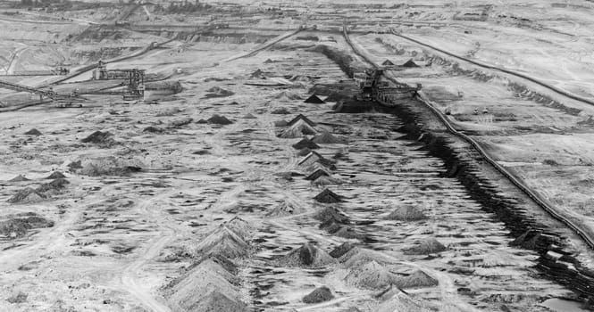 Coal mining in an open pit with huge industrial machine