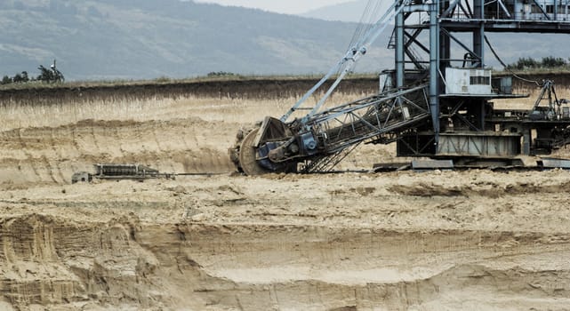 Coal mining in an open pit with huge industrial machine