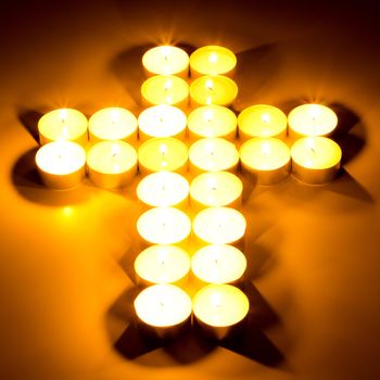 Christian cross made with tea candles