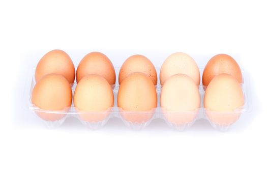 Ten eggs in a plastic transparent package on white background