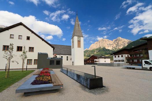 square with church and fountain in Corvara, Badia Valley, Alto Adige, Italy