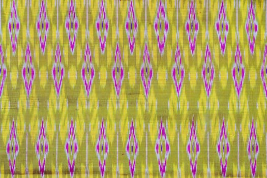 photograph of a pattern yellow and purple. Asian fabric texture